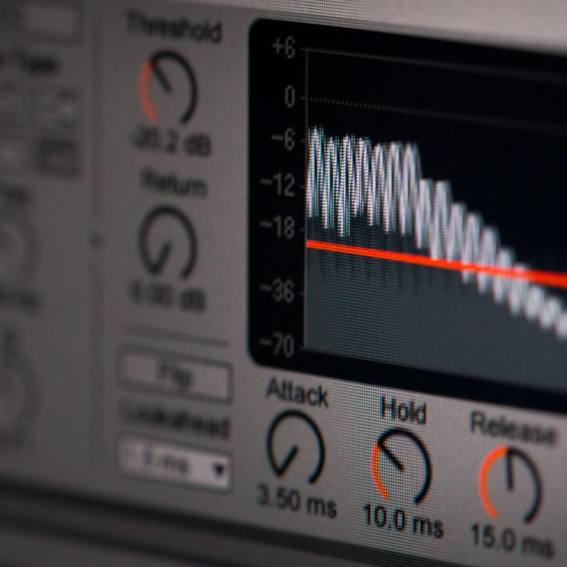 Close-up of audio editing software interface featuring waveform and controls.