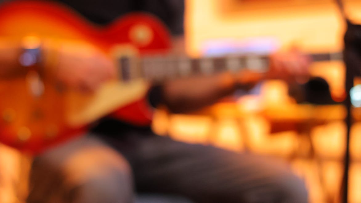 Black and white photo of a gaming controller on a wooden table, perfect for gaming or tech themes.