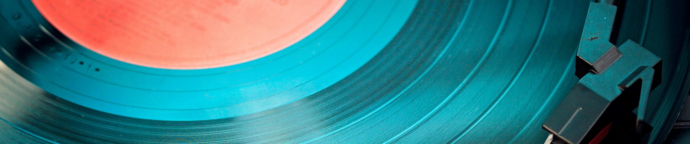 A detailed close-up view of a vintage vinyl record spinning on a turntable, capturing its nostalgic beauty.